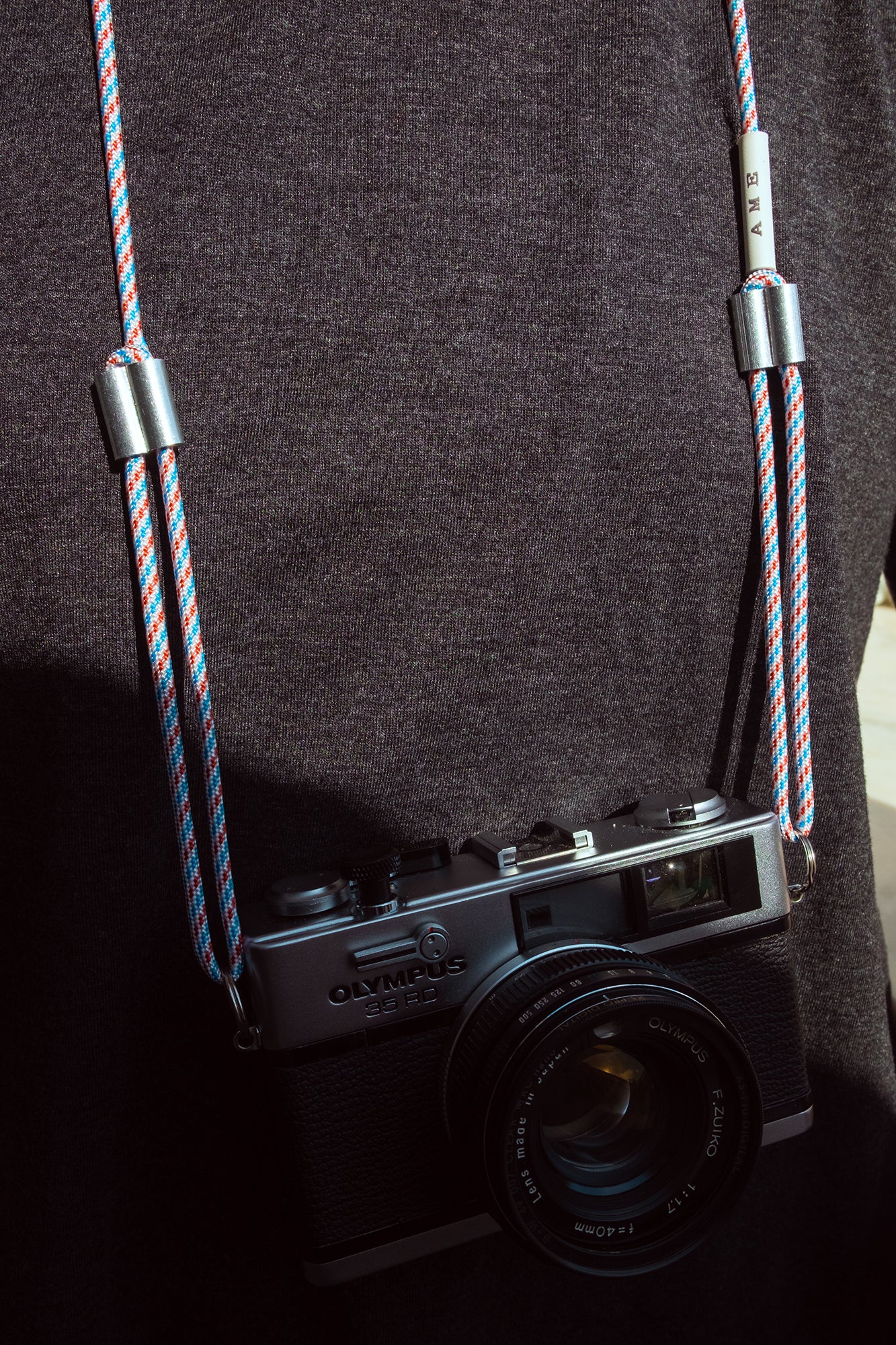 AME x Wolf Camera Strap in der Light Version an einer Kamera. AME x Wolf Camera Strap in der Light Version in verschiedenen Farben. Du finanziert 1 Monat Schule mit dem Kauf.